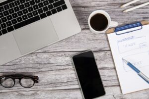 Website designer work table with laptop and a smart phone on a wooden desk